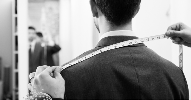 Tailor measuring a suit