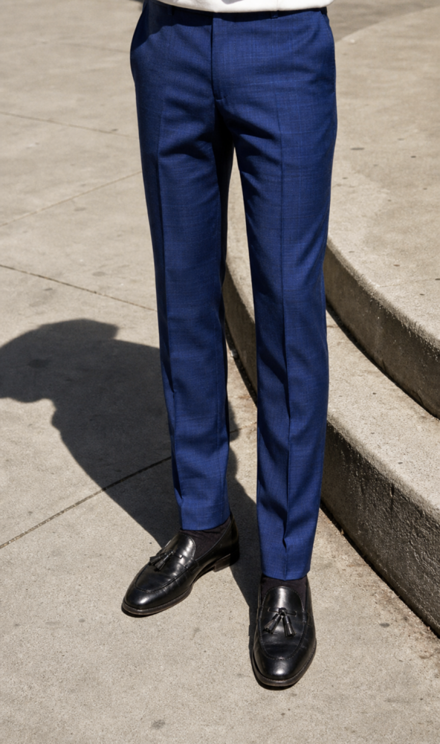 Navy tailored trousers with brown brogue shoes on a bridge
