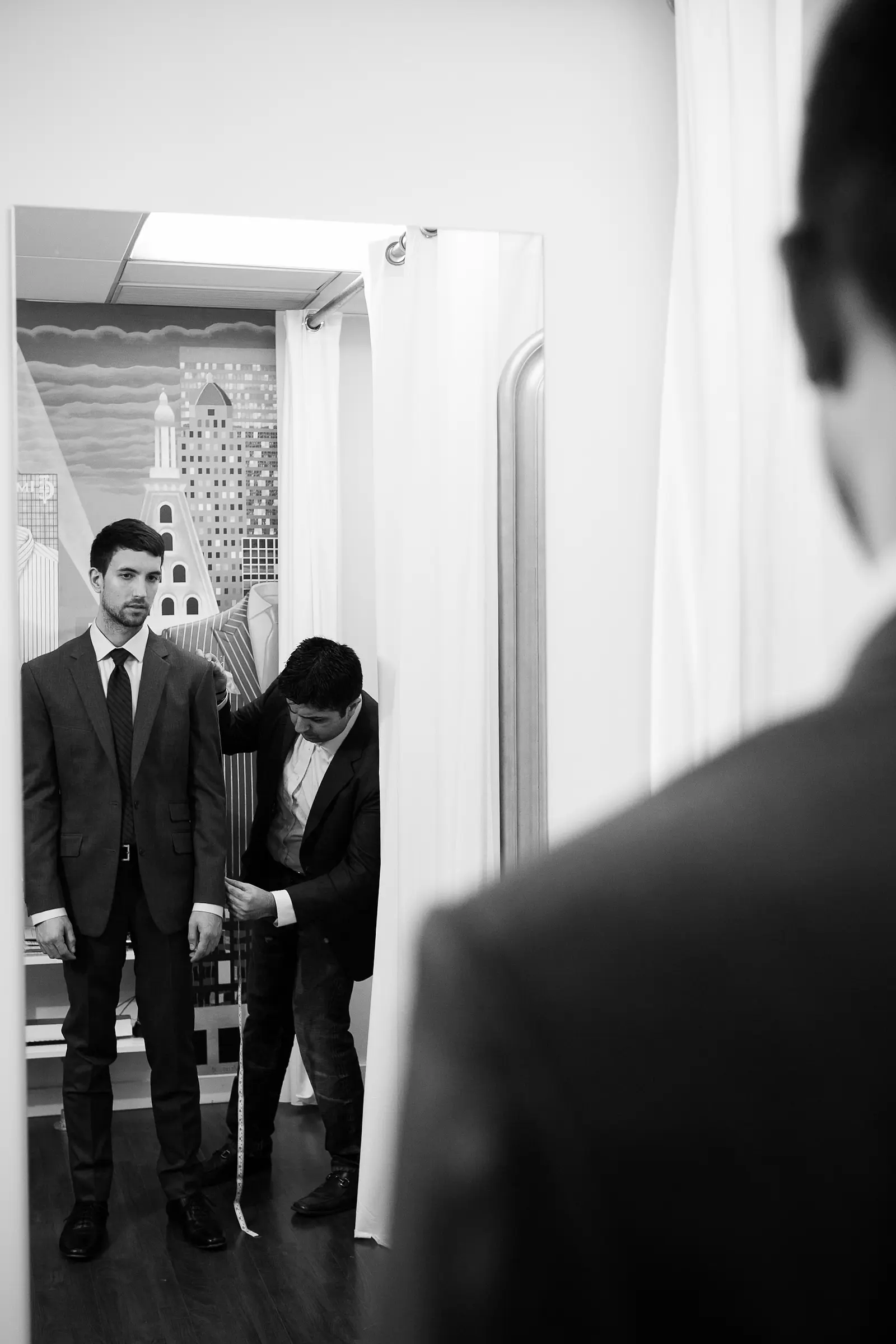 Tailor hand-stitching a custom garment